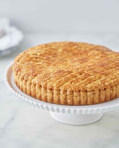 a close up of a pie on a cake plate with the crust removed from it