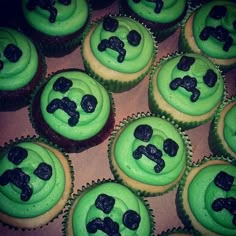 cupcakes with green frosting and black decorations