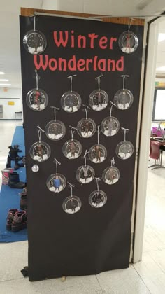 a sign that says winter wonderland hanging from the side of a wall in an airport