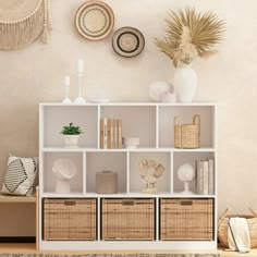 a white shelf with baskets and other items on it