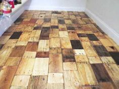 the floor is made out of wood and has many different colored squares on it,