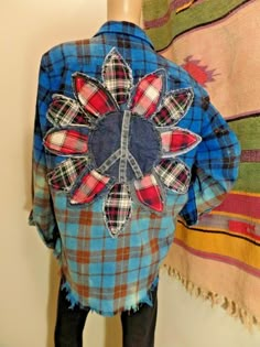 a mannequin wearing a blue plaid shirt and black tights with a flower on it