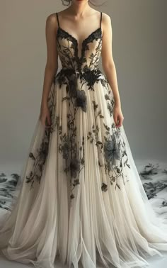 a woman in a long dress with flowers on the bottom and black trimmings