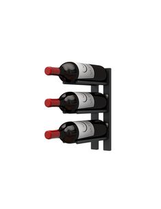 three bottles of wine sitting on top of a black shelf next to each other in front of a white wall