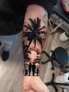 a person with a tattoo on their arm holding up a palm tree and two people