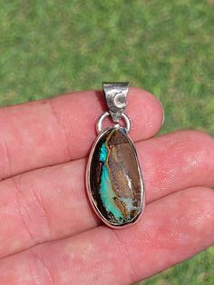 Natural Australian Boulder Opal pendant in 950 Silver with an African goddess and a crescent moon on the back.  This pendant was handmade by a French designer  * Dimensions of the opal: 26 x 15 x 6 mm  * Dimensions of the pendant (with bail): 38 x 15 x 6 mm  * Total weight of the pendant: 6.64g  The silver chain on the photo is free  Other silver chains are also available on our Etsy shop African Goddess, Boulder Opal Pendant, Australian Boulder Opal, Silver Chains, French Designer, Opal Pendants, Boulder Opal, French Design, Crescent Moon