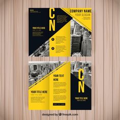 a yellow and black business brochure on wooden background