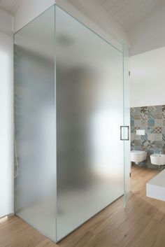 a glass walled shower stall in a modern bathroom