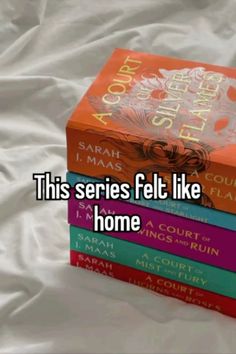 three books stacked on top of each other in front of a white sheet that says, this series felt like home