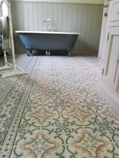 a bath tub sitting in the middle of a bathroom