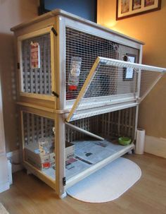 a bird cage sitting on top of a wooden floor