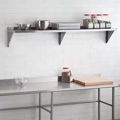 a kitchen counter with two shelves above it