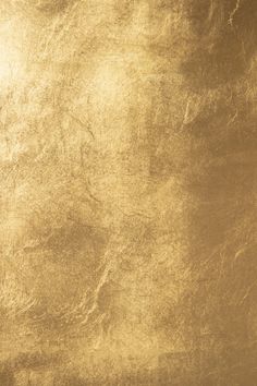 an image of a gold textured background that looks like it has been scratched or stained