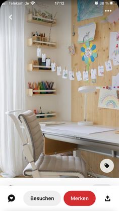 a white desk and chair in front of a wooden wall with lots of pictures on it