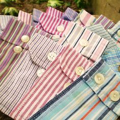 several different colored shirts with buttons on them