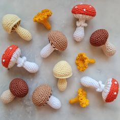 small crocheted mushrooms are arranged on a table