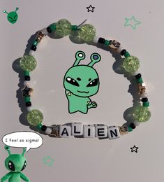 a beaded bracelet with an alien charm on it and a cartoon character in the middle