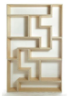 a white and beige wall hanging on the side of a building with an abstract design