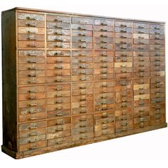 an old wooden filing cabinet filled with lots of drawers