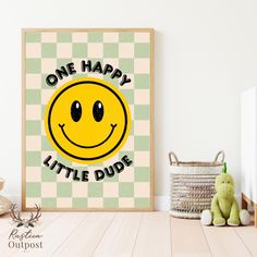 a yellow smiley face on a green and white checkered background with the words, one happy little dude