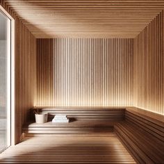 an empty sauna with wooden walls and benches