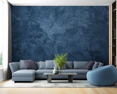 a living room with blue walls and a large couch in front of a coffee table