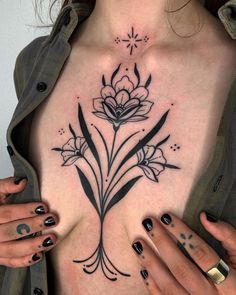 a woman's chest with flowers on it and her hands in front of her