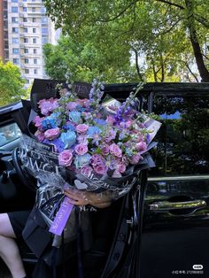 a bouquet of flowers sitting in the back of a car