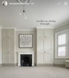 an empty living room with white walls and carpeted flooring is featured in this image