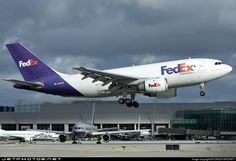 a fedex airplane taking off from an airport