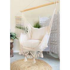 a white hammock chair sitting on top of a rug