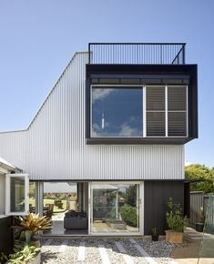 a modern house with an open patio and sliding glass doors