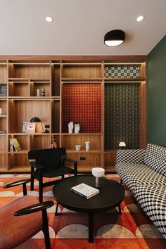 a living room filled with lots of furniture and bookshelves next to each other