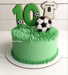 a soccer themed birthday cake with the number ten on it and a soccer ball in the grass