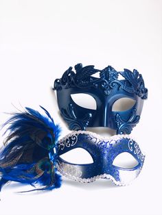 This Venetian Blue Mask Pair is the ultimate duo for elegant masquerade events. The women’s mask features intricate silver filigree and blue glitter accents, complemented by peacock feathers for a dramatic flair. The men’s mask offers a regal blue crown design, making it a statement piece for formal events and masquerade balls. Perfect for couples looking to match their style and sophistication. Age Group/Gender - Adult/Unisex Size/Type - One size fits all adults Mask Colors - Blue/gold/black Ma Elegant Blue Masquerade Mask For Parties, Elegant Blue Eye Mask For Masquerade, Blue Venetian Masquerade Mask For Party, Blue Venetian Mask For Carnival, Blue Venetian Masks For Carnival, Blue Masquerade Mask For Mardi Gras Costume Party, Blue Masquerade Mask For Mardi Gras Carnival, Blue Masks And Prosthetics For Carnival Party, Blue Party Eye Mask