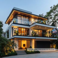 a modern house with lots of windows and plants on the balconies at dusk