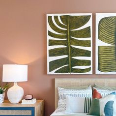 a bedroom with two paintings on the wall