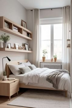 a bedroom with white walls and wooden shelves above the bed is decorated in neutral colors