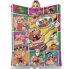 a woman holding up a blanket with cartoon characters on it