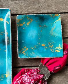 two blue trays sitting next to each other on top of a wooden table,