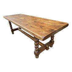 an old wooden table with turned legs