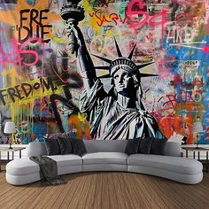 the statue of liberty is painted on a wall in this living room, with graffiti all over it