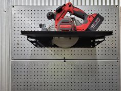 a cordless saw and power tool sitting on top of a shelf