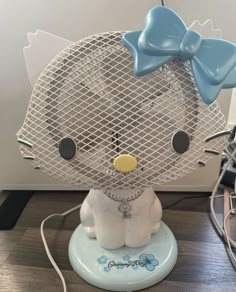 a white and blue hello kitty figurine sitting on top of a table