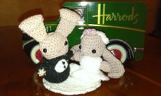 two crocheted bunnies sitting next to each other on top of a table