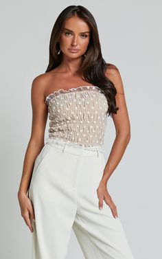 Get ready to turn heads at your next party or festival with the Harper Top - Frill Shirred Bandeau Crop Top in White/Nude! This stunning bandeau top features a delicate mesh fabric that adds a touch of elegance to any outfit. The shirred bodice provides a flattering, body-hugging fit that is both comfortable and stylish. Made from high-quality polyester, this crop top is designed to keep you looking fabulous all night long. Whether you pair it with high-waisted jeans for a casual look or dress i Strapless Summer Party Corset, Summer Tube Top With Sweetheart Neckline And Boned Bodice, Party Bandeau Nylon Top, Summer Party Corset With Boned Bodice, Party Nylon Bandeau Top, Nylon Bandeau Top For Party, Sheer Summer Party Corset, Sheer Corset For Summer Parties, Fitted Tube Top With Boned Bodice For Summer