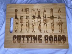 a cutting board that has some knives on it and the words cutting board written in cursive writing