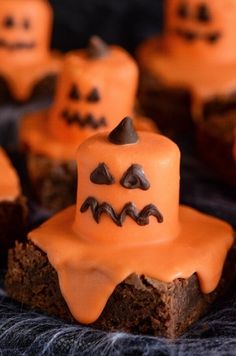 halloween desserts with orange frosting and chocolate sprinkles on black cloth