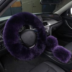 the steering wheel cover has purple fur on it