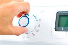 a person is pressing buttons on an appliance to change the time and temperature